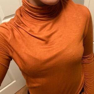 Long-sleeved orange turtleneck perfect for fall